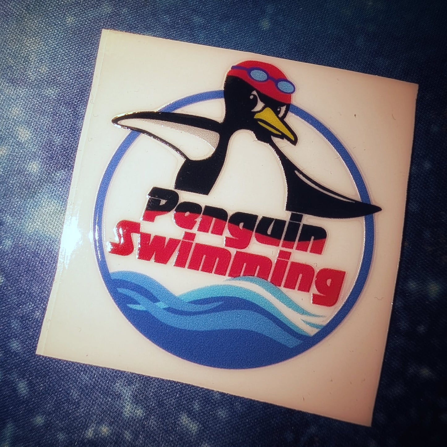 Penguin Swimming Circle Logo UV Sticker